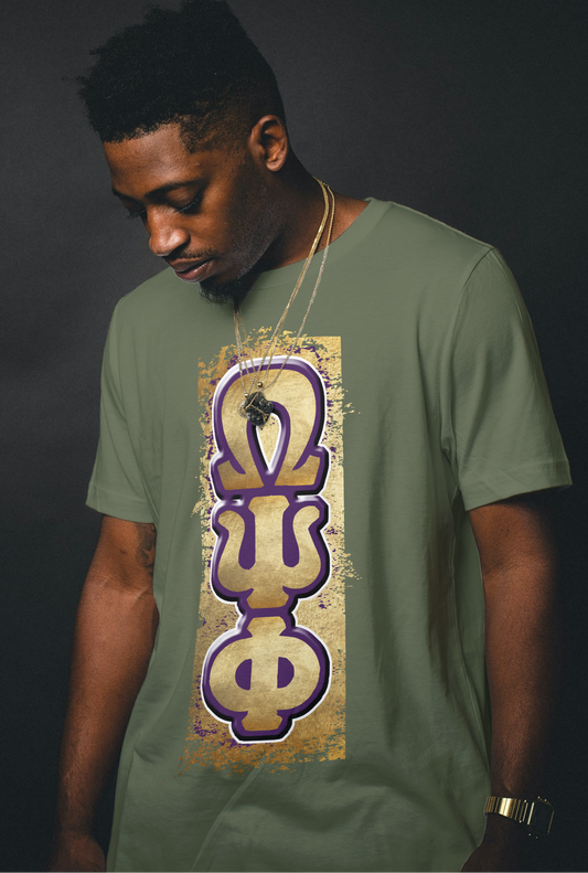 Man wearing a green t-shirt with a QUE PSI PHI Omega Psi Phi symbol on a dark background